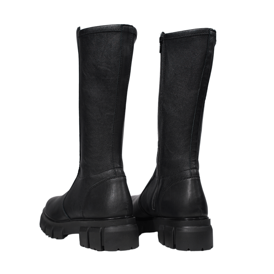 High black leather boots from the back, showcasing elegant design and thick soles for optimal comfort.